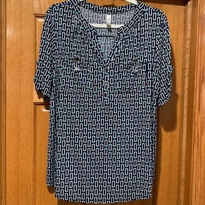 Short sleeve v-neck button, pull over blouse with front pockets.